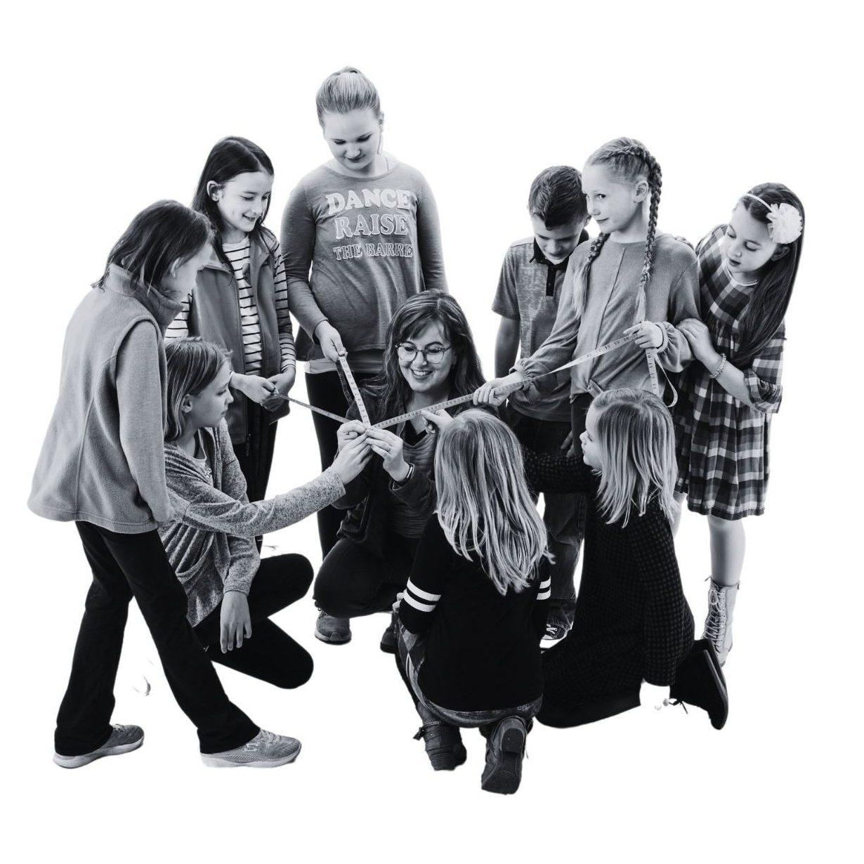 Students gather around a teacher with tape measures to learn about the circle.