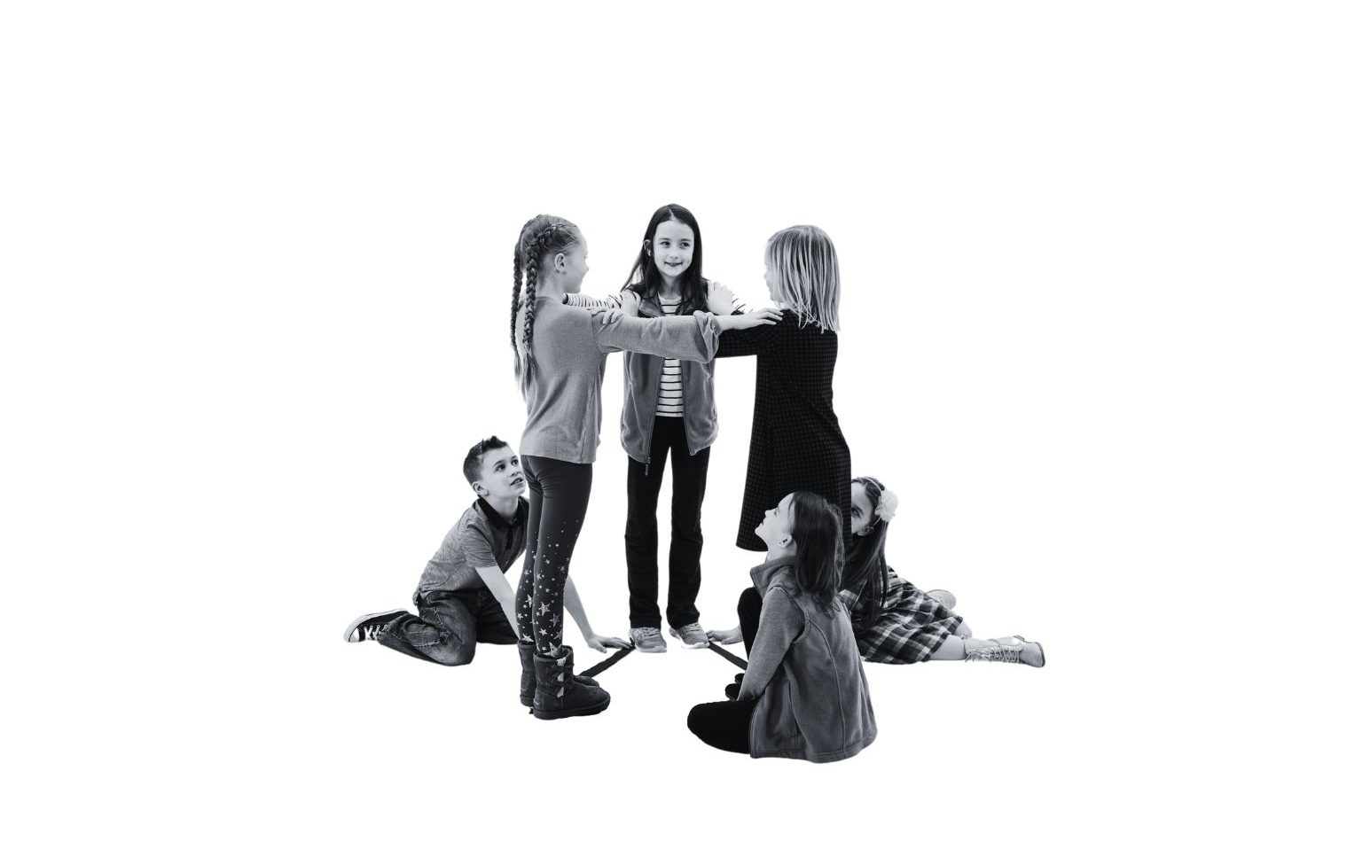 A group of young students making a triangular prism.