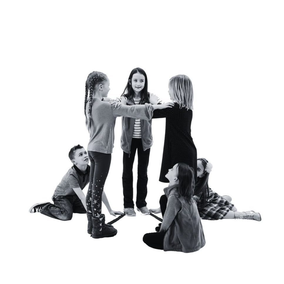 A group of young students making a triangular prism.
